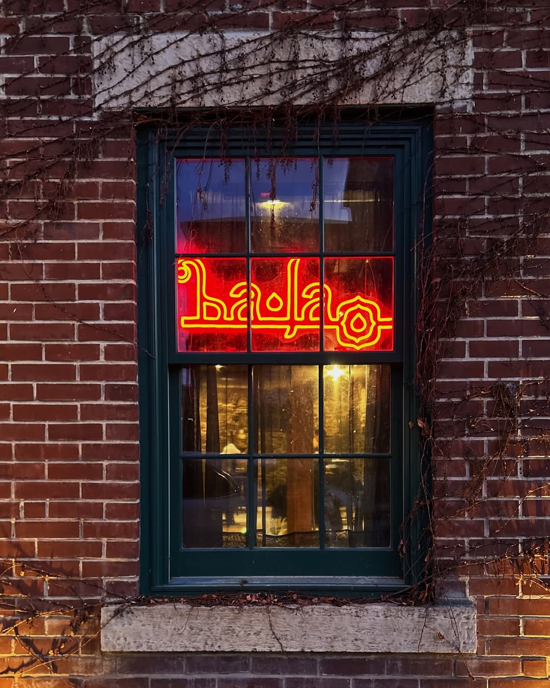 Inside Ba Lao — bar area with Sabaidee neon sign